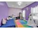 Colorful ' bedroom with a play area, featuring a bed, storage, and play equipment at 7278 Waterwheel St, Concord, NC 28025