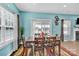 Bright dining room with a wooden table, chairs, colorful rug, and natural light from the window at 7278 Waterwheel St, Concord, NC 28025