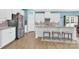 This immaculate kitchen features stainless steel appliances, granite countertops, and breakfast bar with stool seating at 7278 Waterwheel St, Concord, NC 28025