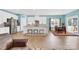 Bright, eat-in kitchen boasts white cabinetry, stainless appliances, granite countertops, and seating at the peninsula at 7278 Waterwheel St, Concord, NC 28025