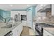 This expansive kitchen features stainless steel appliances, granite countertops, and tile backsplash at 7278 Waterwheel St, Concord, NC 28025