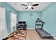 Bright office space with natural light, featuring a desk, chair, and exercise equipment at 7278 Waterwheel St, Concord, NC 28025