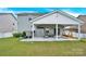 Covered patio with plenty of seating and a porch swing provides outdoor living space at 7278 Waterwheel St, Concord, NC 28025
