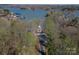 An aerial shot revealing a home nestled amidst mature trees with lake views at 8172 Summit Ridge Dr, Catawba, NC 28609
