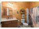 Well-lit bathroom with wood paneling, decorative accents, and a convenient shower at 8172 Summit Ridge Dr, Catawba, NC 28609