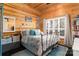 Charming bedroom with wood-paneled walls, natural light, and stylish furnishings at 8172 Summit Ridge Dr, Catawba, NC 28609
