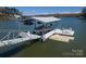 Private covered boat dock featuring boat slip, boat, and entertaining space on the water at 8172 Summit Ridge Dr, Catawba, NC 28609
