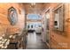 Inviting entryway with wood paneling, stylish console table, and a glimpse into the living area at 8172 Summit Ridge Dr, Catawba, NC 28609