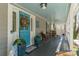 Inviting front porch features a beautiful blue door, stylish decor, and comfortable seating at 8172 Summit Ridge Dr, Catawba, NC 28609