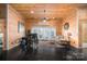 Cozy living room with wood walls, ceiling fan, and view of the deck at 8172 Summit Ridge Dr, Catawba, NC 28609