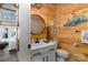 Charming powder room with wood paneling and unique nautical-themed decor at 8172 Summit Ridge Dr, Catawba, NC 28609