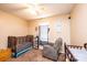 A cozy bedroom featuring two cribs, chair and a calming interior design at 87 Green Meadows Dr, Taylorsville, NC 28681