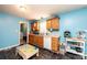 The kitchen is light and bright with wood cabinets, white appliances and black tile flooring at 87 Green Meadows Dr, Taylorsville, NC 28681