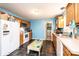 Well lit kitchen with wood cabinets, white appliances and black tile flooring at 87 Green Meadows Dr, Taylorsville, NC 28681