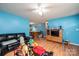 Bright living room with a dark leather sofa, entertainment center and lots of light at 87 Green Meadows Dr, Taylorsville, NC 28681