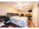 Well-lit main bedroom with a spacious bed, hardwood floors, and ample storage at 87 Green Meadows Dr, Taylorsville, NC 28681