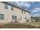 Exterior showcasing the backyard, offering a concrete patio, and utility features with a view of surrounding residences at 9035 Bradstreet Commons Way, Charlotte, NC 28215