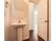 Bathroom featuring pedestal sink, mirror, white door, and views into the home's interior at 9035 Bradstreet Commons Way, Charlotte, NC 28215