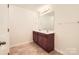 Bathroom featuring a double sink with wood cabinets, large mirror, and tile floors at 9035 Bradstreet Commons Way, Charlotte, NC 28215