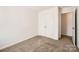 A cozy bedroom with carpet, a double-door closet, and a doorway offering comfort and storage at 9035 Bradstreet Commons Way, Charlotte, NC 28215