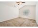 Empty bedroom with vaulted ceilings, carpeted floors, and a bright window at 9035 Bradstreet Commons Way, Charlotte, NC 28215