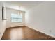 Dining room featuring hardwood floors, a hanging light fixture, a large window, and base molding at 9035 Bradstreet Commons Way, Charlotte, NC 28215