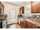 Updated kitchen features stainless steel appliances, wood cabinets, granite countertops, and mosaic tile backsplash at 9035 Bradstreet Commons Way, Charlotte, NC 28215