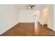 Living room featuring hardwood floors, ceiling fan, a neutral color palette, and base molding at 9035 Bradstreet Commons Way, Charlotte, NC 28215