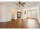 Spacious living room featuring hardwood floors, ceiling fan and open sightlines to the kitchen at 9035 Bradstreet Commons Way, Charlotte, NC 28215