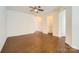 Spacious living room featuring hardwood floors, ceiling fan, a neutral color palette, and base molding at 9035 Bradstreet Commons Way, Charlotte, NC 28215