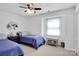 Cozy bedroom with twin beds, natural light and a ceiling fan at 9808 Emerald Point Dr # 10, Charlotte, NC 28278