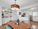 Dining room featuring a stylish light fixture, built-in bar and barstools perfect for dining and entertaining at 9808 Emerald Point Dr # 10, Charlotte, NC 28278