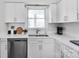 Bright kitchen sink with stainless steel appliances, white cabinetry, and a spacious quartz countertop at 9808 Emerald Point Dr # 10, Charlotte, NC 28278