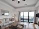 Spacious living room with modern decor, neutral color palette, and a sliding glass door to a patio and lake view at 9808 Emerald Point Dr # 10, Charlotte, NC 28278