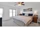 Bright bedroom with plush carpet, ceiling fan, and outdoor access at 9808 Emerald Point Dr # 10, Charlotte, NC 28278