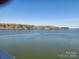 Stunning lake view featuring calm waters, tree-lined shores, and a clear blue sky at 9808 Emerald Point Dr # 10, Charlotte, NC 28278