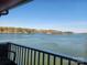 Relaxing balcony view of a serene lake with distant shoreline and clear blue sky at 9808 Emerald Point Dr # 10, Charlotte, NC 28278