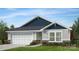 Charming single-story home featuring a two-car garage, stone accents, horizontal siding, and a shingled roof at 1018 Cunningham Farm Dr, Indian Trail, NC 28079