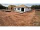 Under-construction home exterior showcasing the frame and concrete slab for a new build at 1018 Cunningham Farm Dr, Indian Trail, NC 28079