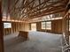 Spacious unfinished room with wood framing, large window openings, and natural light at 1018 Cunningham Farm Dr, Indian Trail, NC 28079