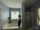 Bright bathroom featuring a tub, plants, and a window at 1015 Raywood Ct, Matthews, NC 28104