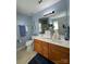 Bright bathroom with a double vanity, large mirror, and light blue walls at 1015 Raywood Ct, Matthews, NC 28104
