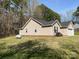 Side view of a cozy home with a backyard, trees and grass at 1015 Raywood Ct, Matthews, NC 28104