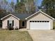 Charming single-story home with a two-car garage, well-kept lawn, and welcoming entryway at 1015 Raywood Ct, Matthews, NC 28104