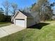 Spacious detached garage with a white door and driveway at 1015 Raywood Ct, Matthews, NC 28104