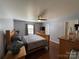 Main bedroom with hardwood floors, ceiling fan, neutral walls, and a comfortable queen-sized bed at 1015 Raywood Ct, Matthews, NC 28104