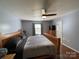 Main bedroom with hardwood floors, ceiling fan, neutral walls, and a comfortable queen-sized bed at 1015 Raywood Ct, Matthews, NC 28104