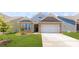 Charming single-story home with stone accents, a two-car garage, and a well-manicured front lawn at 110 S Shayna Rd, Troutman, NC 28166
