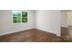 Bright bedroom with hardwood floors and a large window offering a view of the outdoors at 115 S Shayna Rd, Troutman, NC 28166