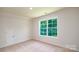 Bright bedroom with carpet, a large window, and ample natural light at 115 S Shayna Rd, Troutman, NC 28166